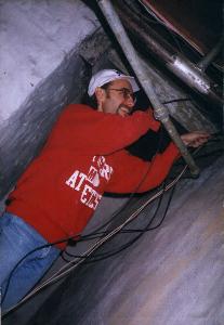 Kevin installing TV and telephone wires in basement